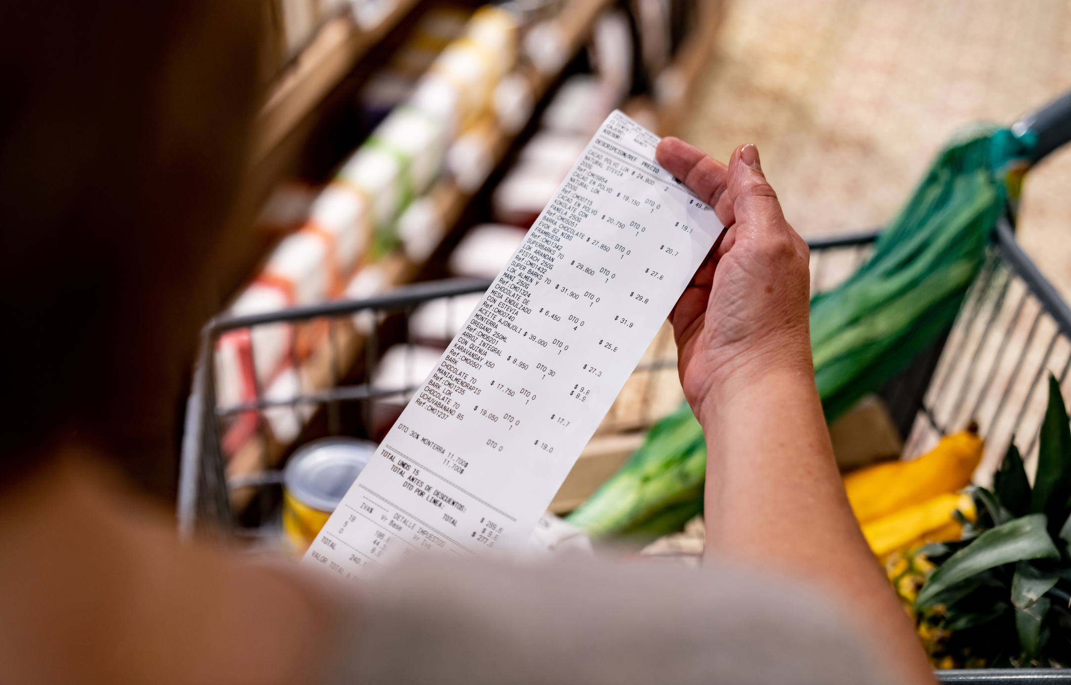 Person holding a grocery receipt, ready to submit to Aisle